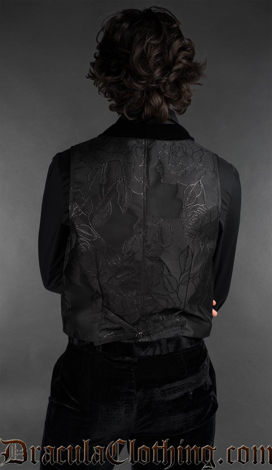 Back view of Goth black brocade vest with a rose pattern and velvet details