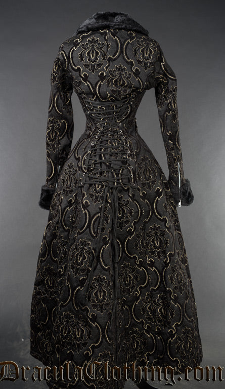 Back view of black and gold jacquard women's coat showing adjustable corset style lacing down the back and zip details on the sleeve cuffs
