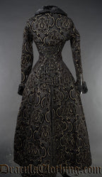 Back view of black and gold jacquard women's coat showing adjustable corset style lacing down the back and zip details on the sleeve cuffs