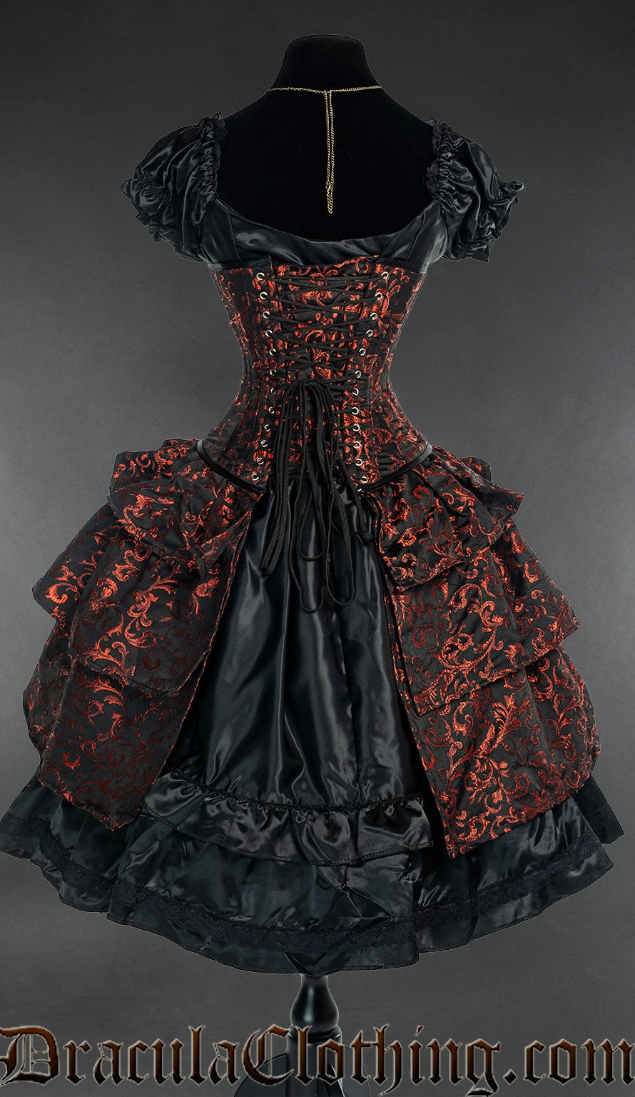 Back view of ruby red and black brocade bustle corset showing bustle skirt and adjustable lacing with matching modesty panel