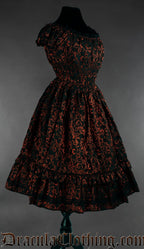 Side view of red and black brocade dress showing highly stretchy waist and sleeves