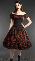 Model wearing black and red brocade knee length dress with black waist cincher