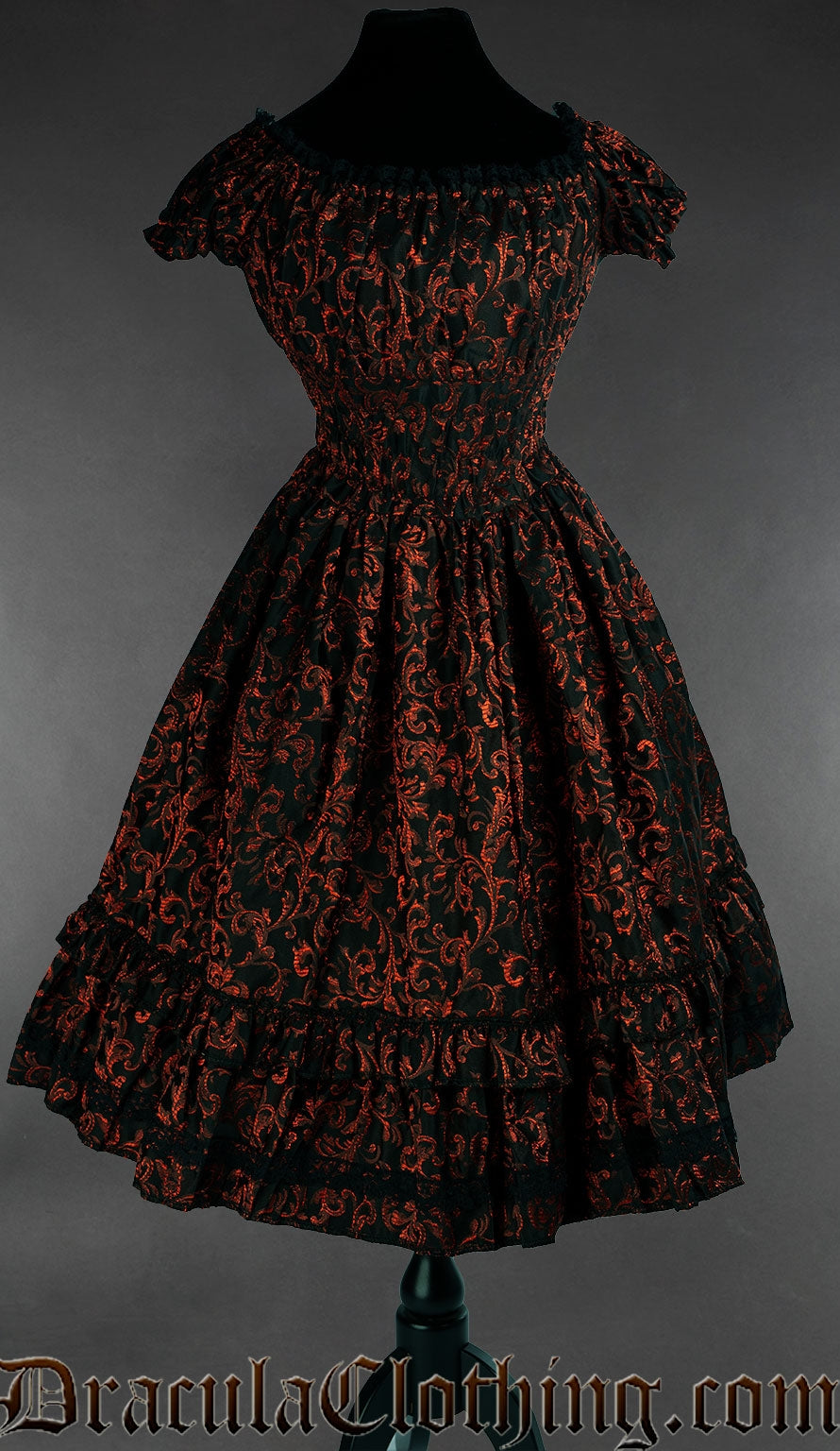 Women's knee length dress with elasticated waist bust and sleeves made using black and red brocade fabric