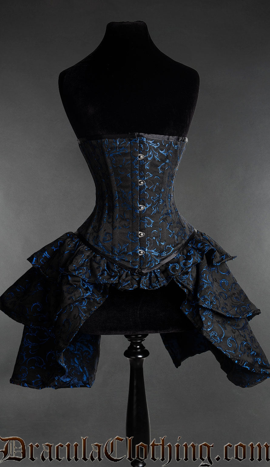 Black brocade corset with layered bustle attachment made with blue woven details 