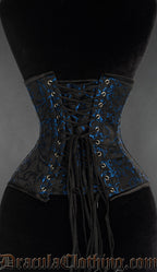 Back view of blue brocade waspie underbust corset showing adjustable lacing and matching modesty panel