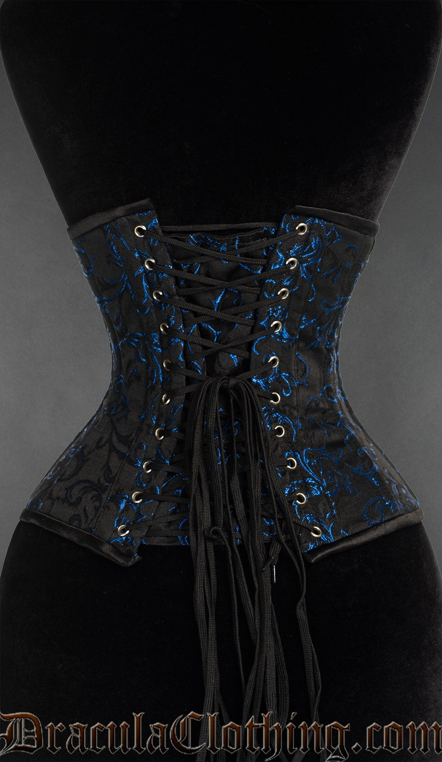 Back view of blue brocade waspie underbust corset showing adjustable lacing and matching modesty panel