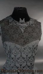 Close up of women's black brocade dress showing bat shaped collar and sheer lace chest panel