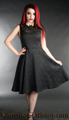 Black brocade knee length dress with lace chest and bat shaped collar worn by model