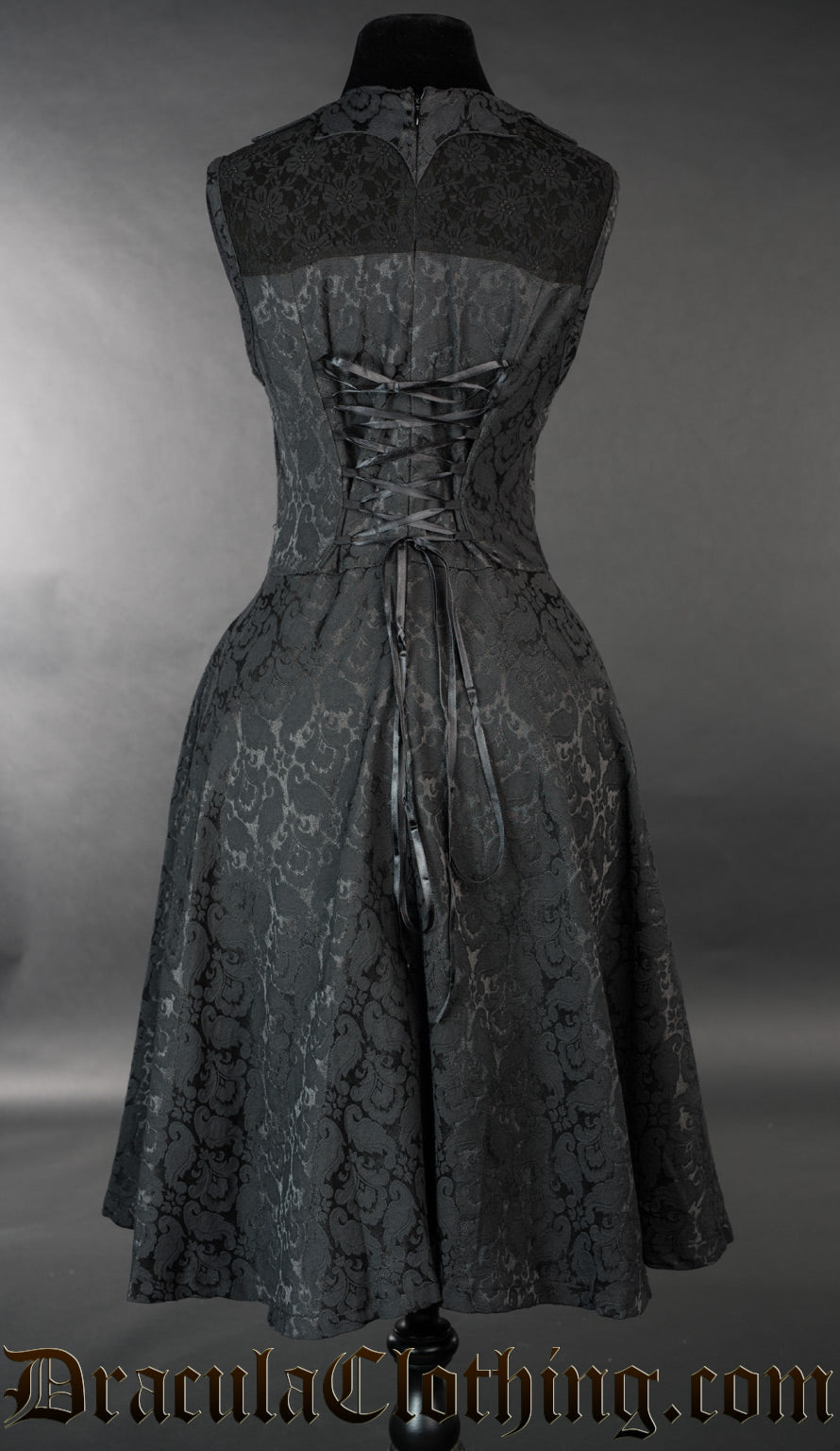 Back of black brocade short bat dress showing adjustable corset style lacing in the back