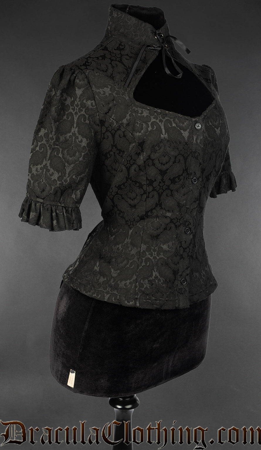 Side view of women's blouse with high collar and keyhole style chest opening made with black brocade fabric 