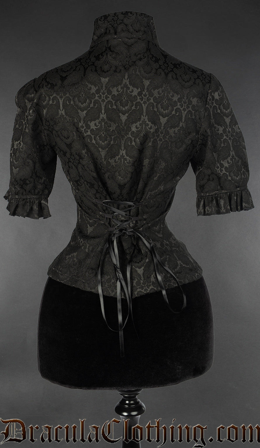 Back view of black brocade keyhole blouse showing adjustable lacing in the torso