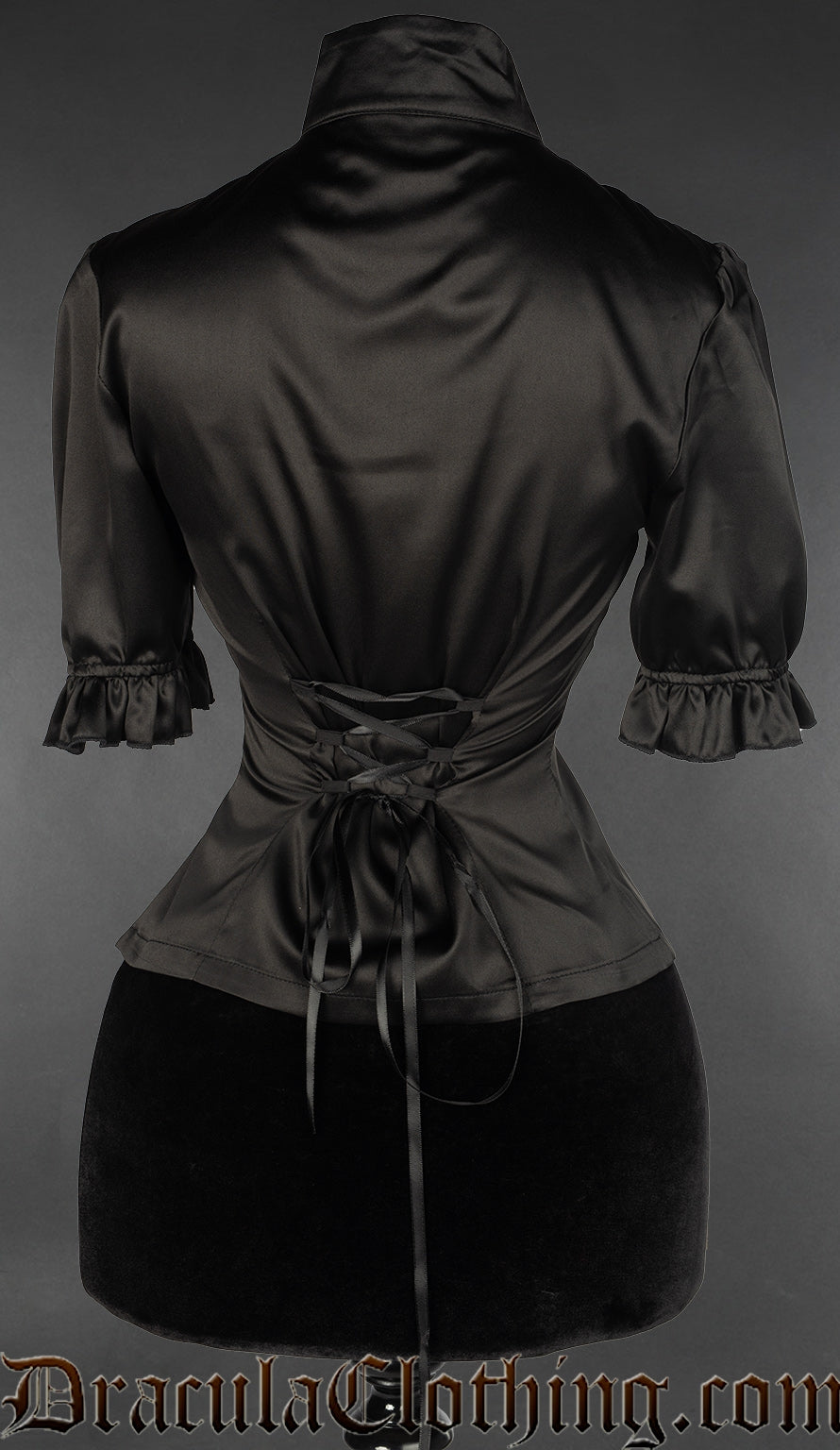 Back view of women's black satin blouse showing frilled short sleeve cuffs and adjustable corset style lacing in the back