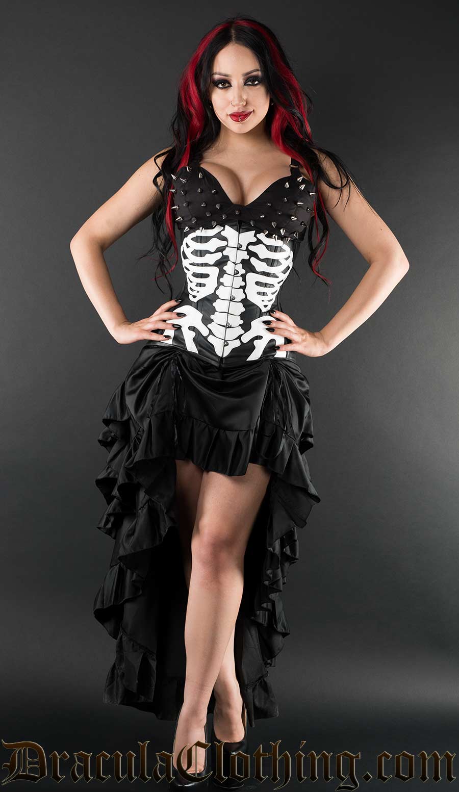 Model with skeleton design faux leather underbust corset worn alongside an additional black bustle skirt