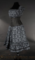 Side view of skull print women's dress showing square neckline elasticated bust and sleeves worn with additional waist cincher