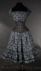 Front view of printed skull pattern black and grey women's dress with elasticated bust shown with additional waist cincher