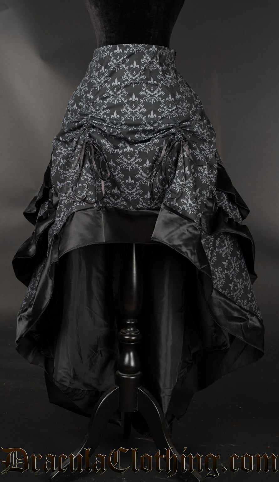 Women's black and grey skull brocade bustle skirt with the front of the skirt raised