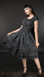 Model wearing black skull damask printed knee length dress