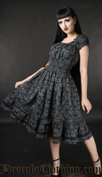 Women's black knee length dress with strechy bust waist and sleeves printed with skull damask pattern in grey