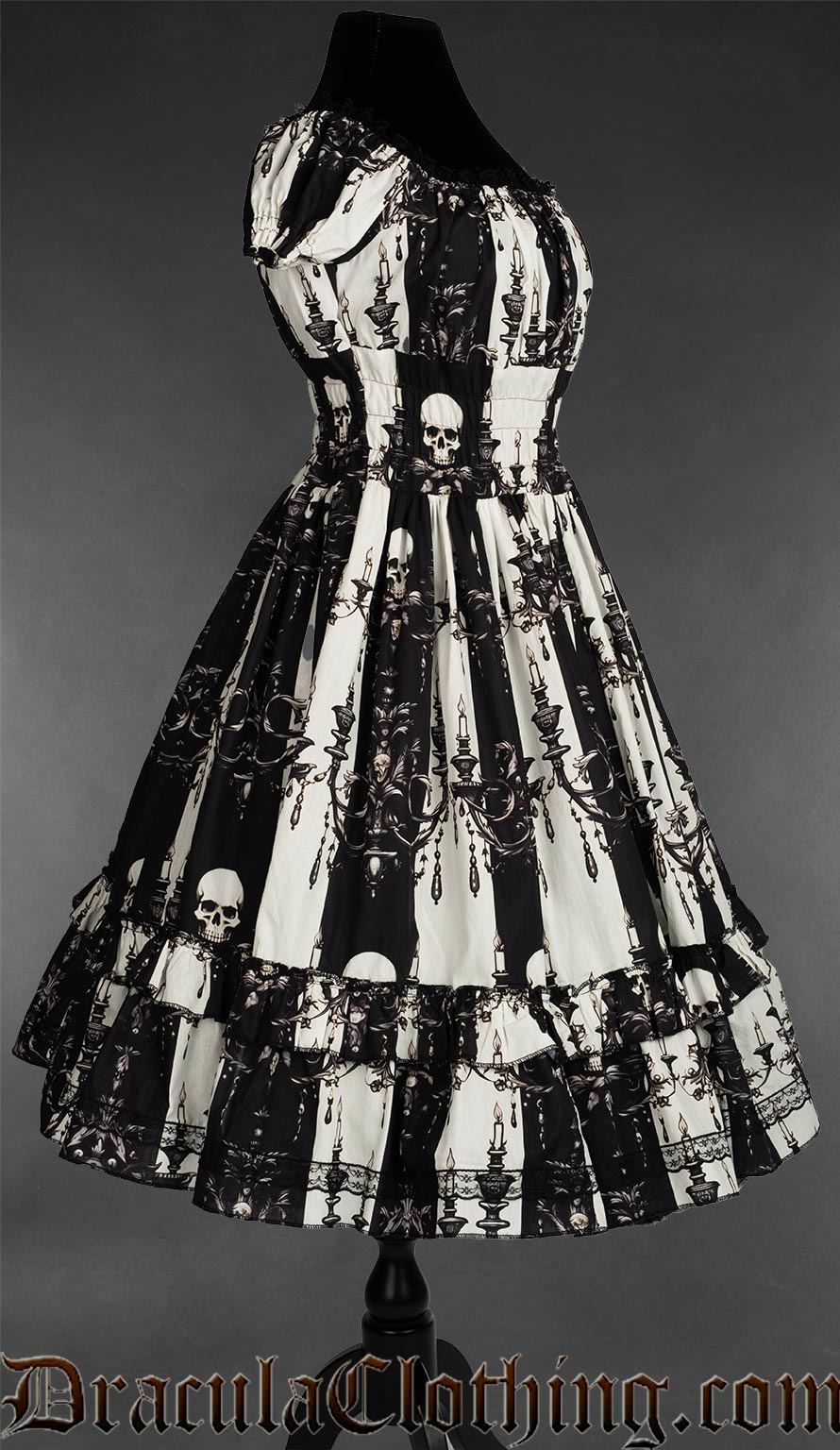 Side view of black and white striped printed skull and candelabra dress for women showing elasticated waist and sleeves