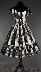 Back view of women's black and white striped dress showing elasticated waist all the way around