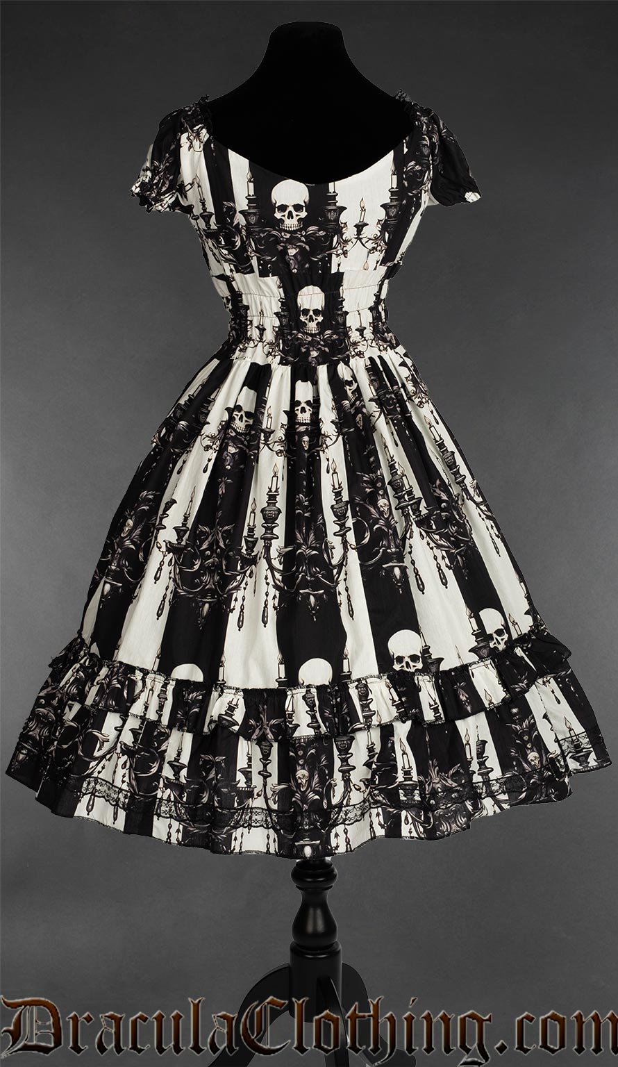 Back view of women's black and white striped dress showing elasticated waist all the way around