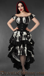 Model wearing black and white striped skull print dress with matching bustle skirt and black waist cincher