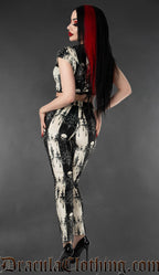 Model wearing black and white gothic skull striped velvet leggings with matching crop top back view
