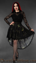 Women's high low skirt with black lace trim and printed sphinx cat design on a black background worn by a model