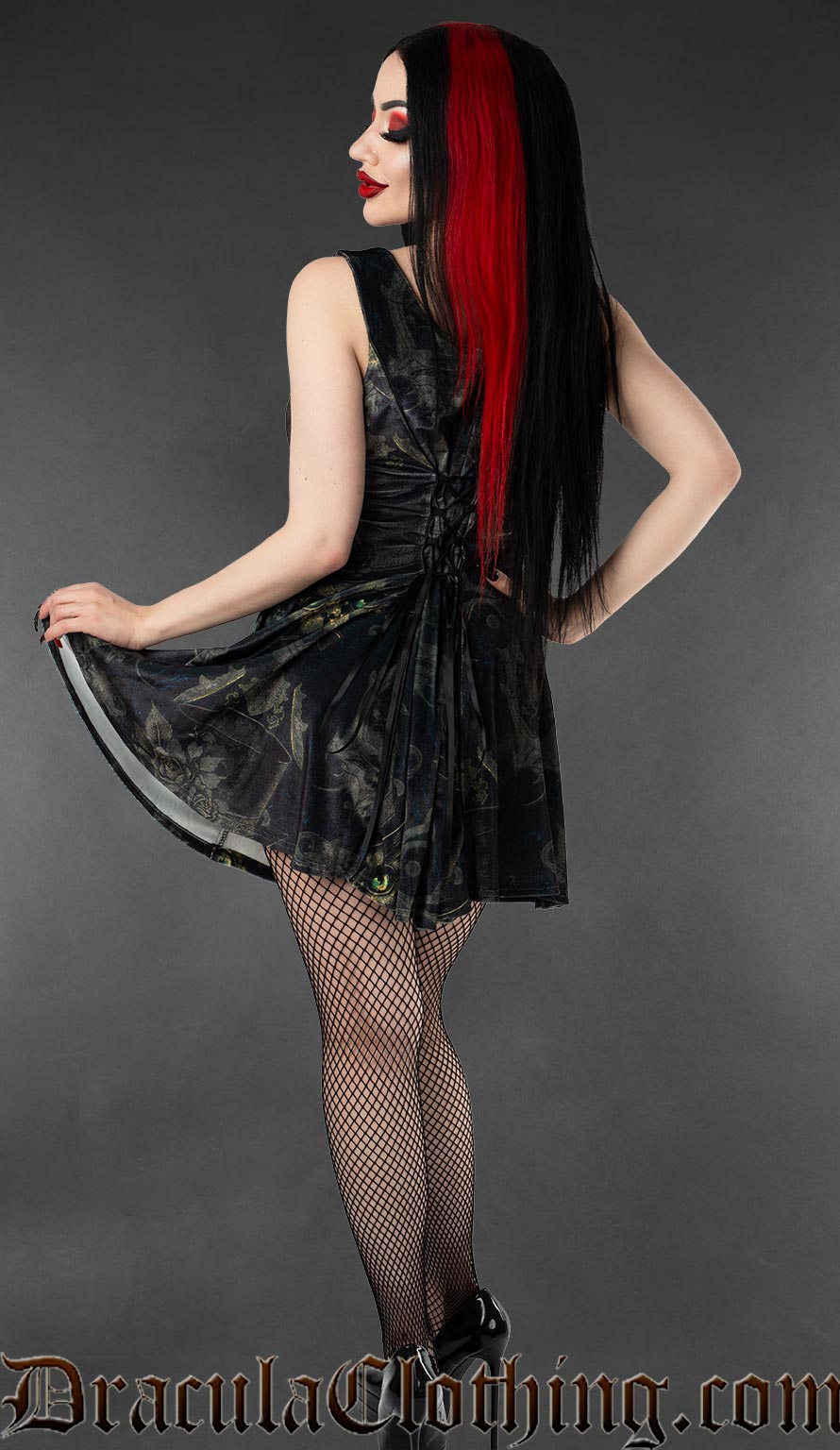 Back view of women's short velvet dress with ornate sphinx cat print and adjustable lacing in the back