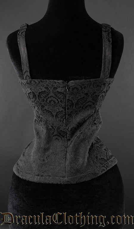 Back view of black brocade spiked blouse showing zip fastening and shoulder straps