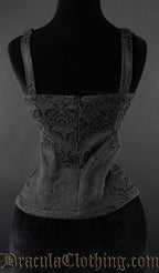 Back view of black brocade spiked blouse showing zip fastening and shoulder straps