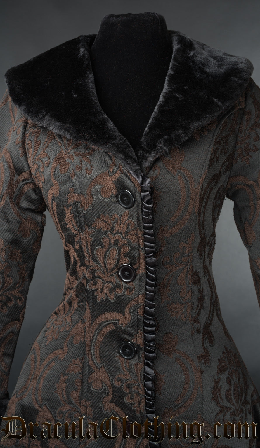 Close up of the faux fur collar and satin trim details on a black and brown  damask patterned brocade women's coat