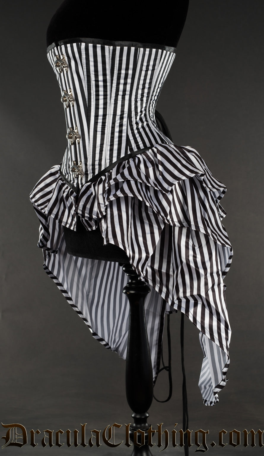 Side view of striped black and white bustle corset showing layered skirt attachment