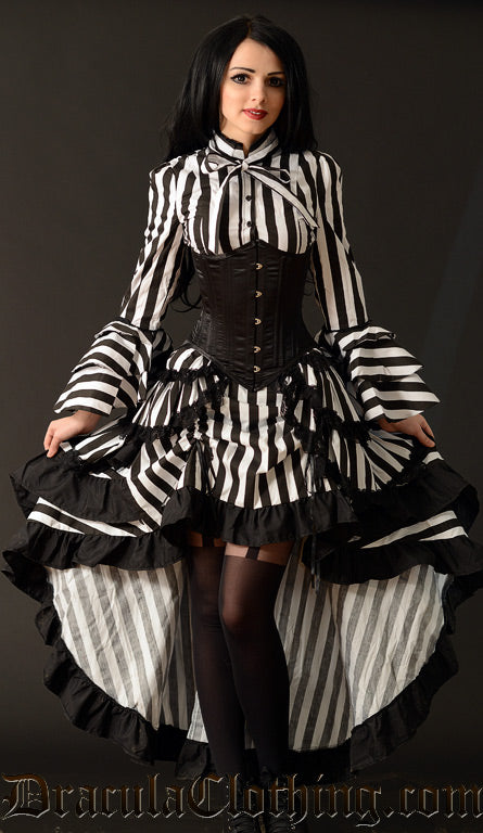Women's black and white striped bustle skirt worn raised in the front for high low look also shown with a corset and striped blouse 