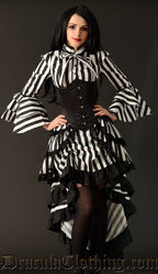 Women's layered bustle skirt with black and white vertical stripes worn by a model with a striped blouse and corset