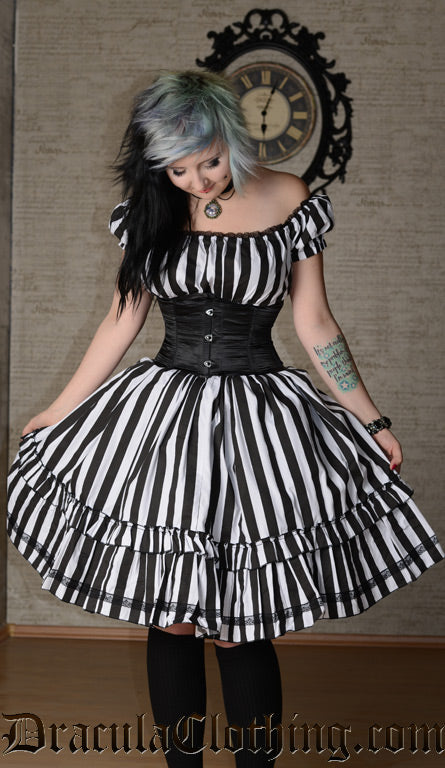 Black and white women's striped knee length dress shown on a model worn with the sleeves styled off shoulder