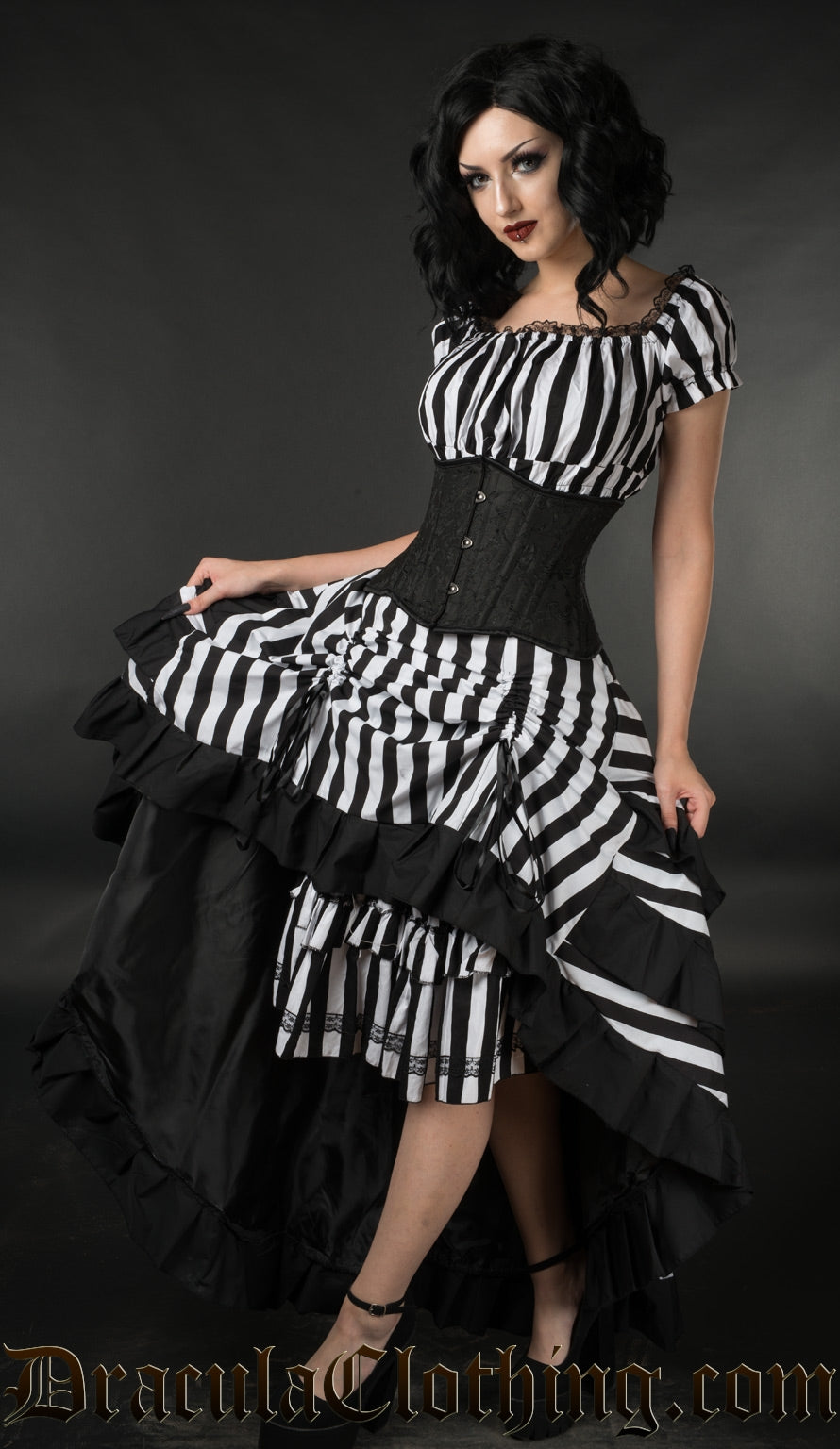 Women's black and white striped dress shown worn with a waist cincher and matching black and white striped bustle skirt
