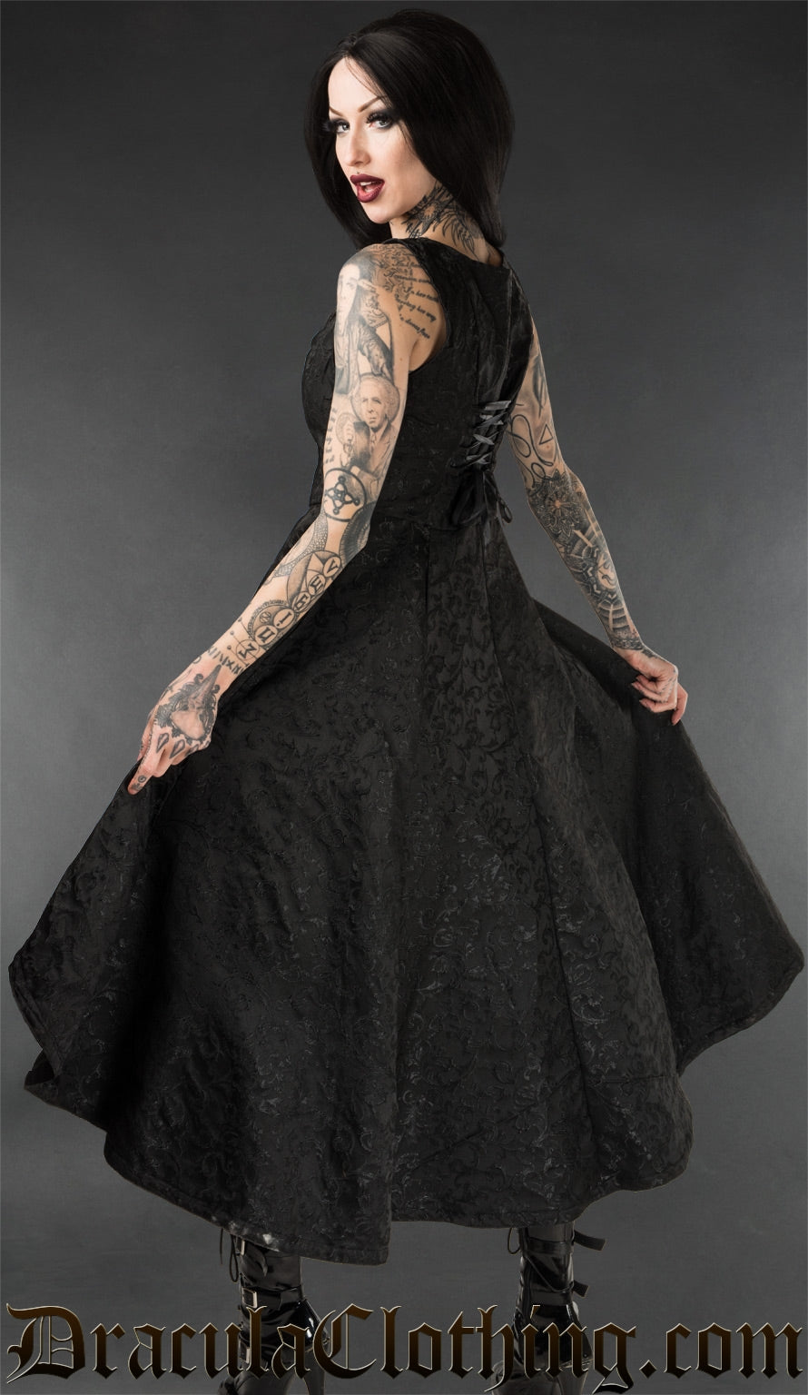 Back and side view of black gothic brocade women's dress showing adjustable lacing on the back