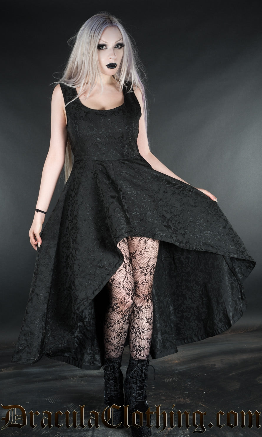 Women's black gothic dress made with woven cotton brocade and showing off a high low style hem