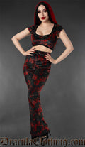 Model wearing black and red velvet flare pants with vampire bat print