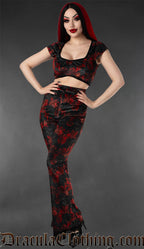 Model wearing black and red velvet flare pants with vampire bat print