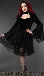 Model wearing black velvet victorian jacket with black lace knee length skirt