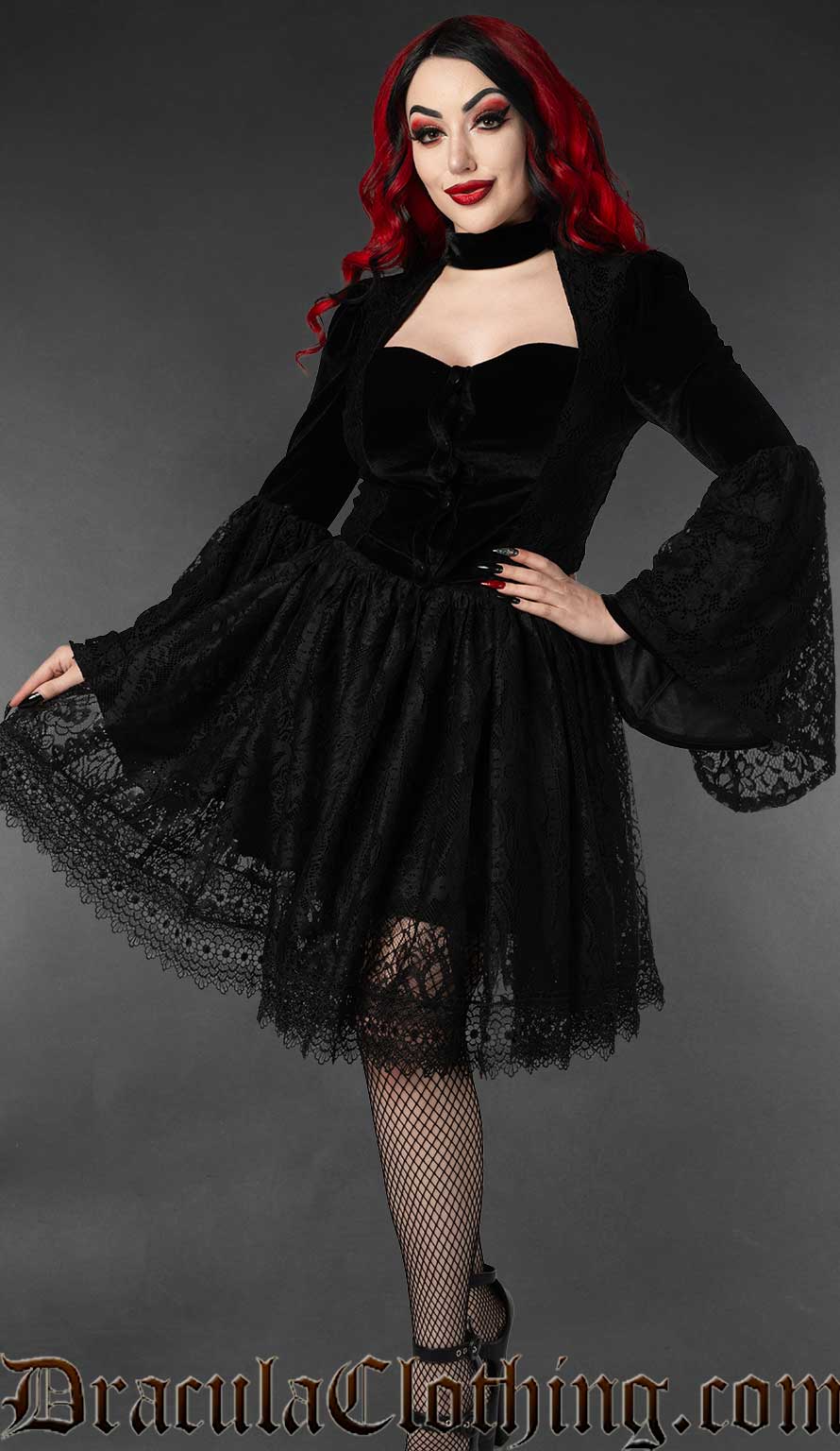 Model wearing black velvet victorian jacket with black lace knee length skirt