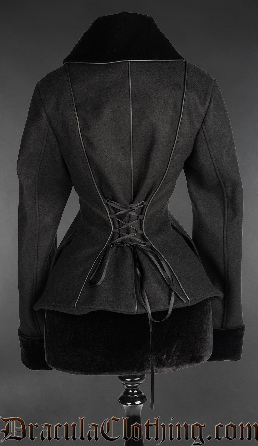 Back view of women's black faux wool jacket showing faux leather piping and adjustable lacing in the back 