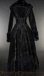 Back view of women's black velvet winter coat with satin details and faux fur trim showing adjustable corset style lacing 