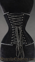 Back view of black velvet extreme waist corset showing matching modesty panel and adjustable lacing