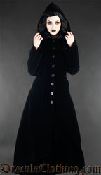 Model wearing black velvet women's coat with the attached hood up