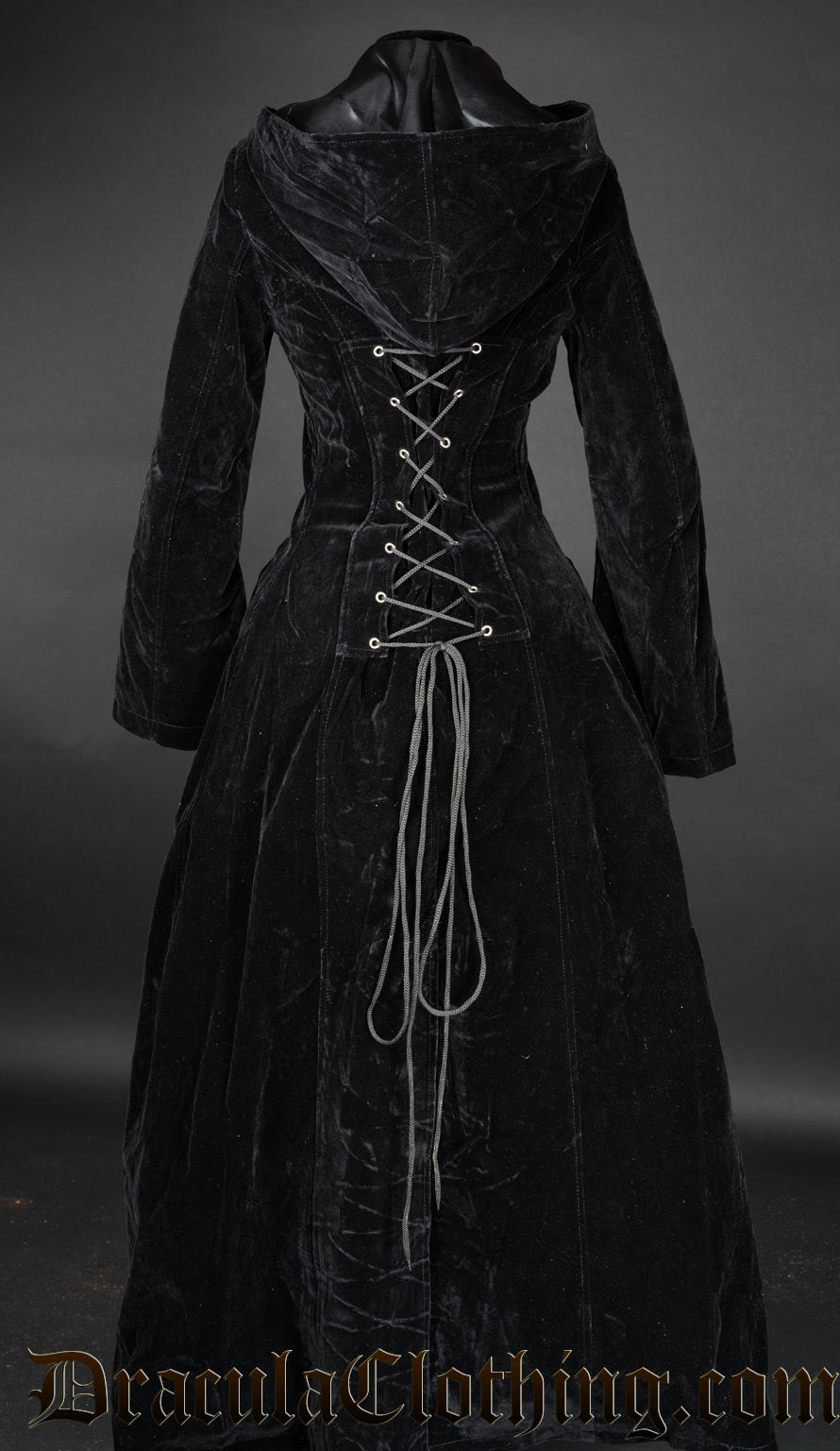Back view of women's long black velvet coat showing clearly adjustable corset style lacing in the back