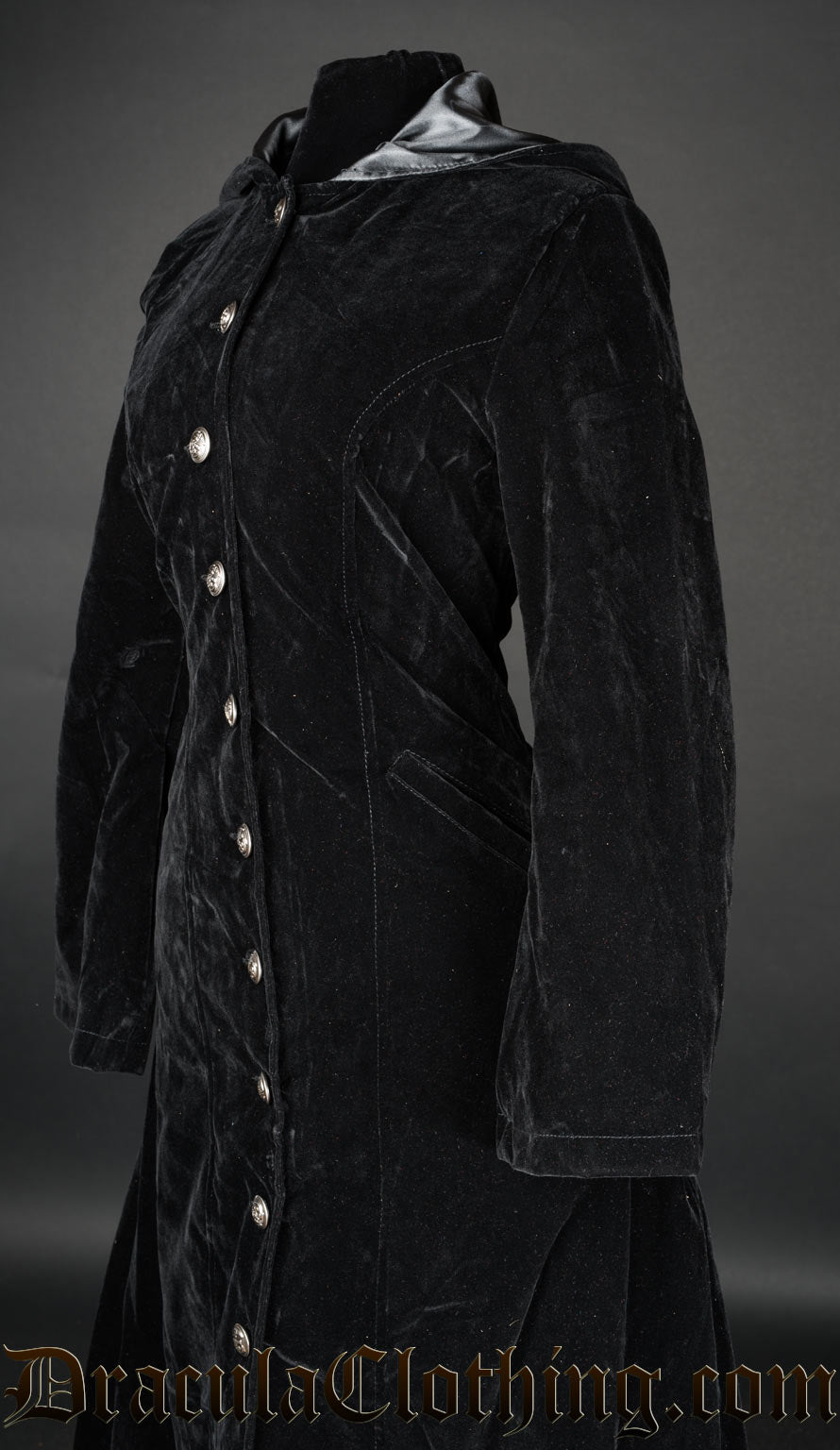 Close up side view of black velvet women's coat showing deep soft fabric and lined hood