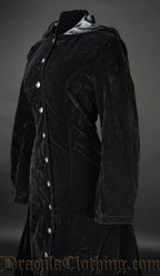 Close up side view of black velvet women's coat showing deep soft fabric and lined hood